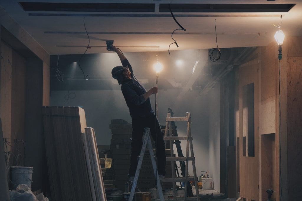 Person painting the ceiling during renovation project